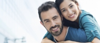 Man and woman smiling after preventive dentistry