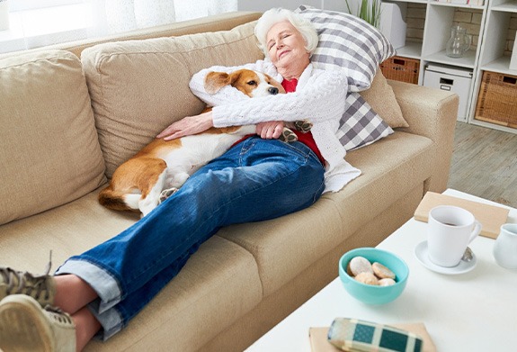 A woman resting after dental implant surgery
