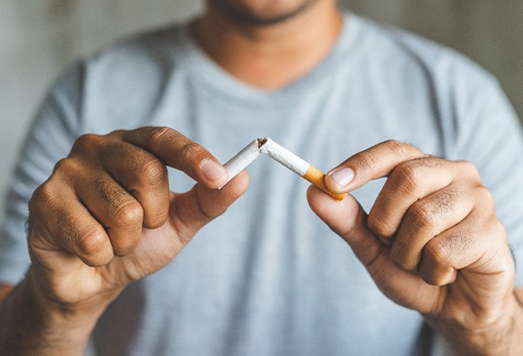 Closeup of patient breaking cigarette