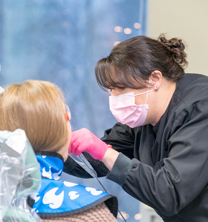 Dental team member treating dentistry patient