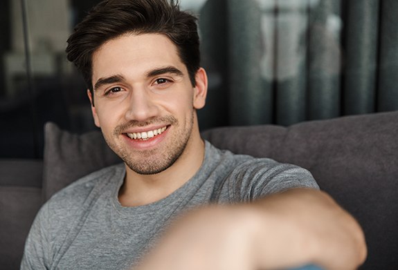 patient smiling after enhancing smile with cosmetic dentistry