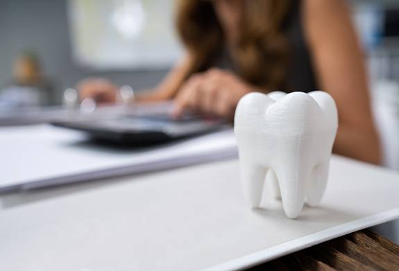 patient calculating cost of cosmetic dentistry