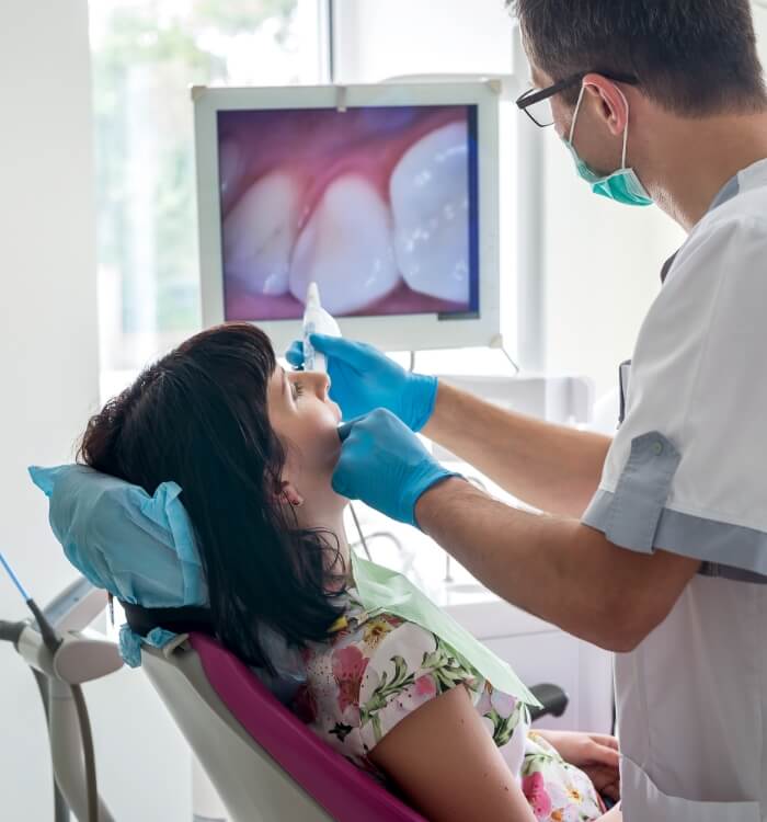 Dentist using intraoral camera to capture smile images