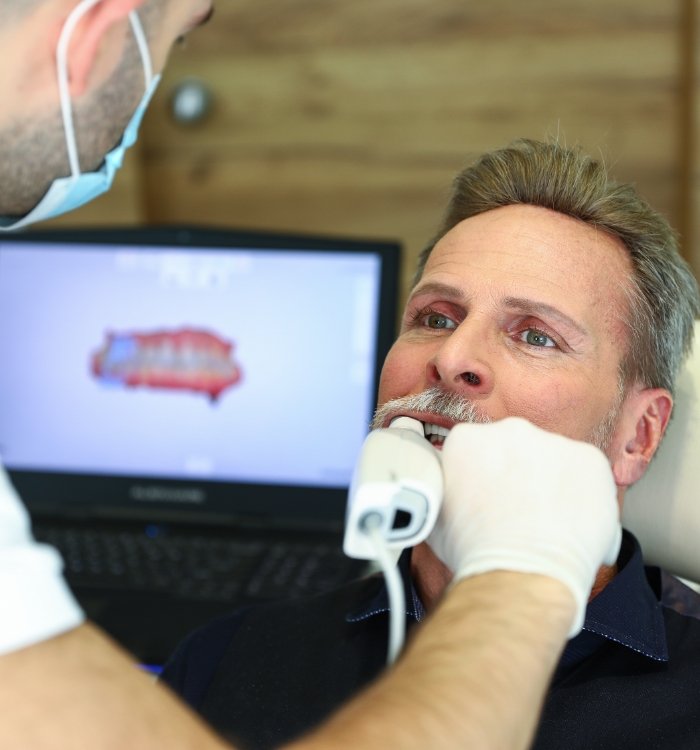 Dentist capturing bite impressions with the Sirona Prime scan intraoral scanner