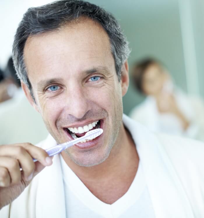 Man brushing teeth to prevent dental emergencies