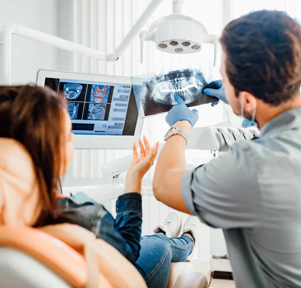 Dentist showing patient her X-rays
