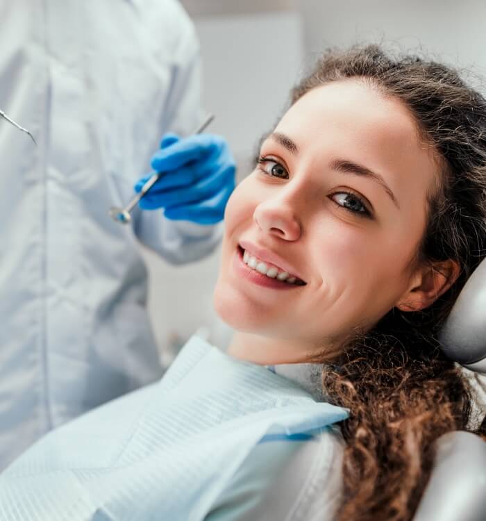 Woman smiling during dental checkup and teeth cleaning visit