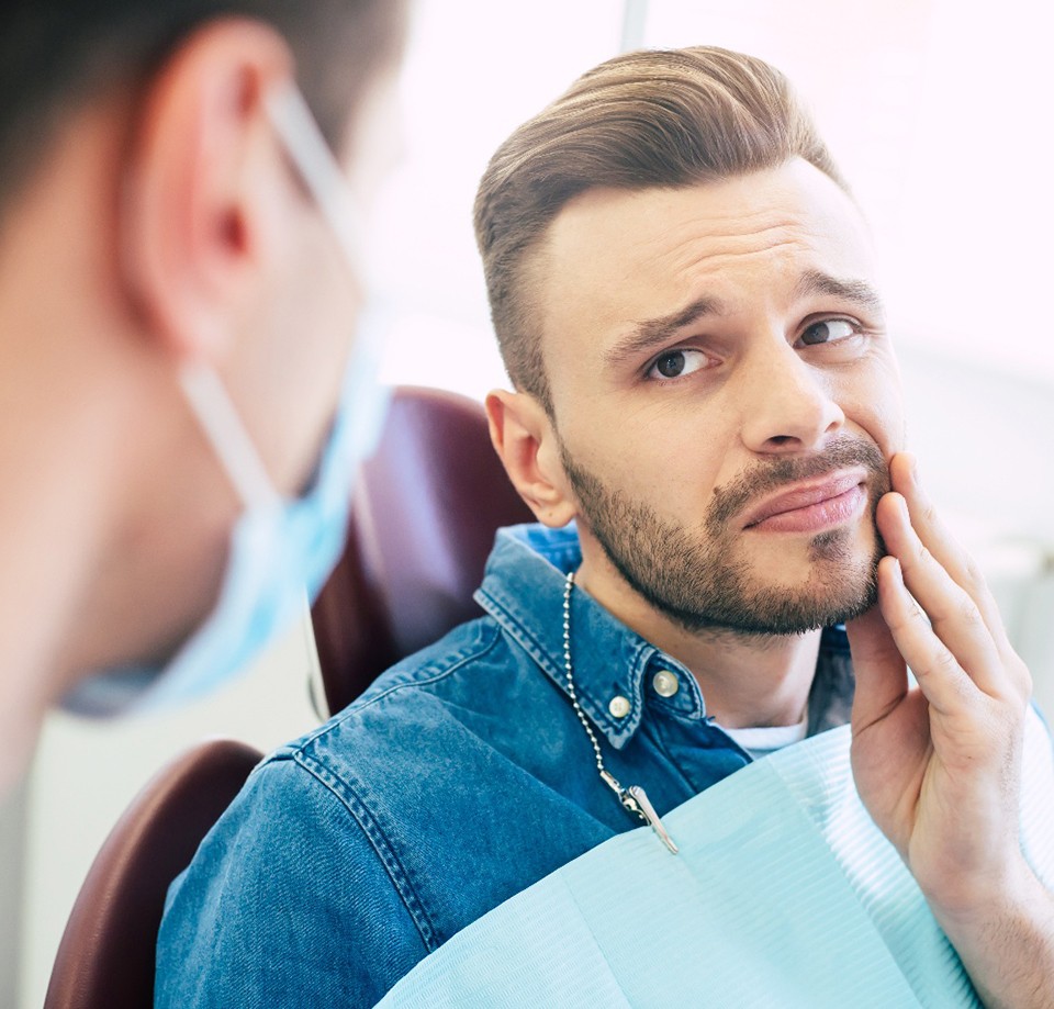 Patient with toothache looking at dentist