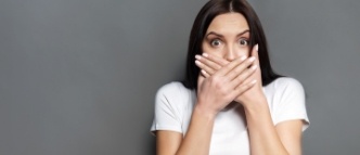 Woman with missing teeth hiding her smile