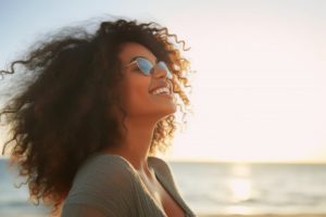 a woman with a beautiful smile enjoying her summer vacation