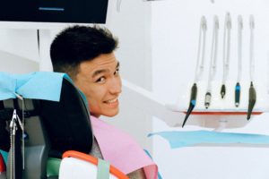 Smiling male patient in dentist’s chair