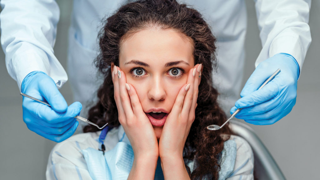 person looking scared at dentist