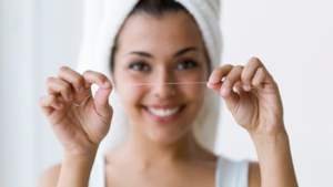 a closeup of a person flossing at home