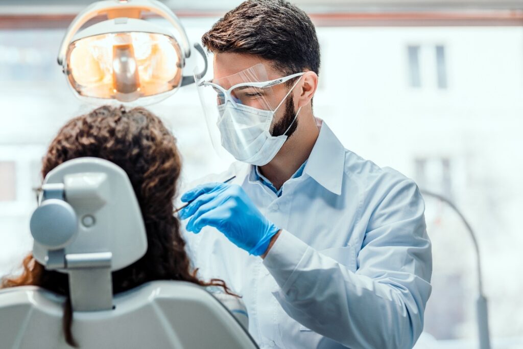 patient at dental appointment being screened for oral cancer