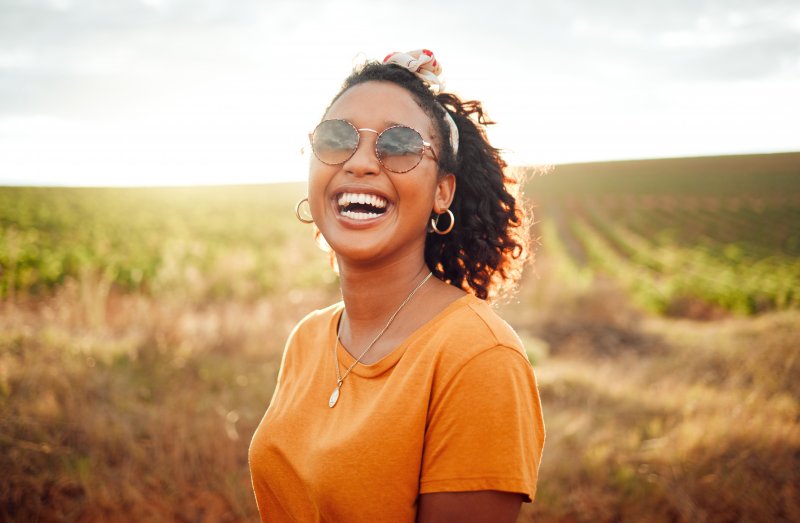 young woman smiling outside