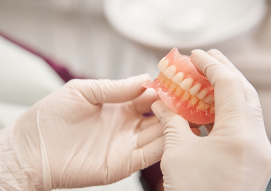 Dentist holding dentures